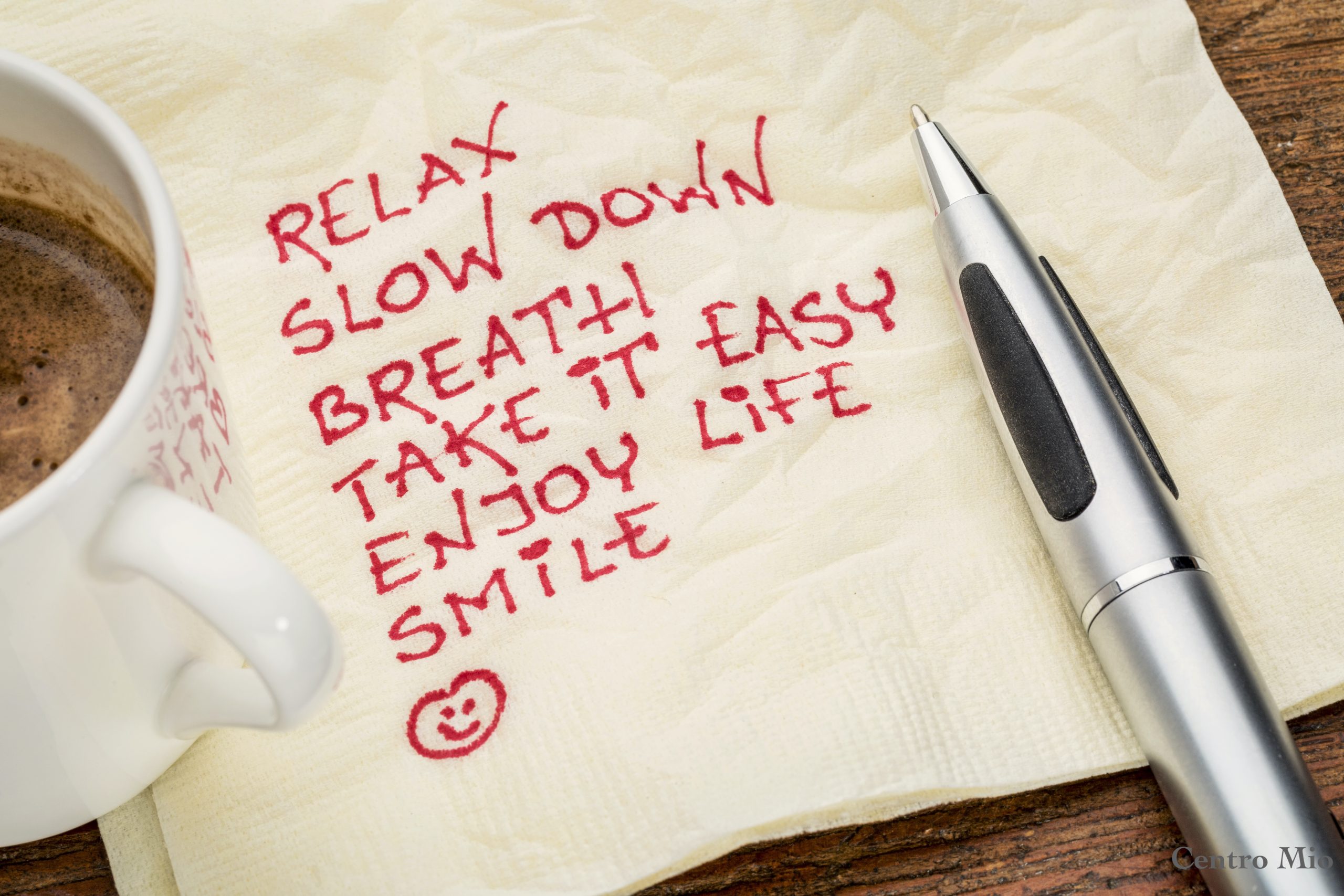 stress reduction concept - relax, slow down, breath, take it easy, enjoy life, smile handwriting on a napkin with a cup of coffee